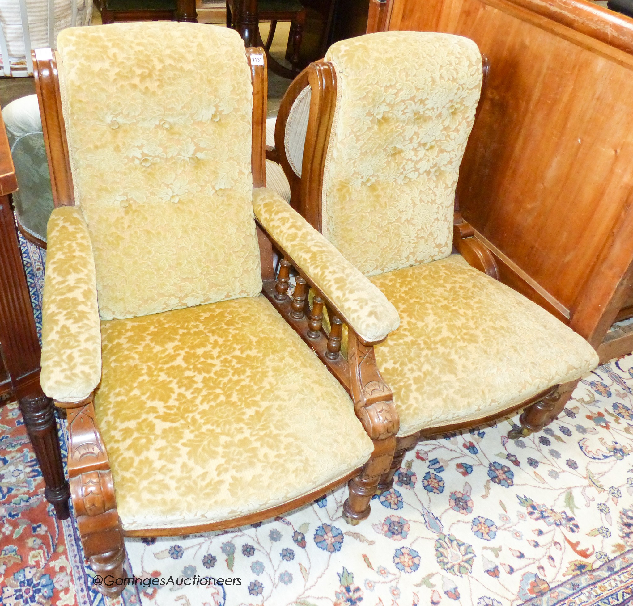 A pair of Victorian carved walnut chairs, (one with arms)